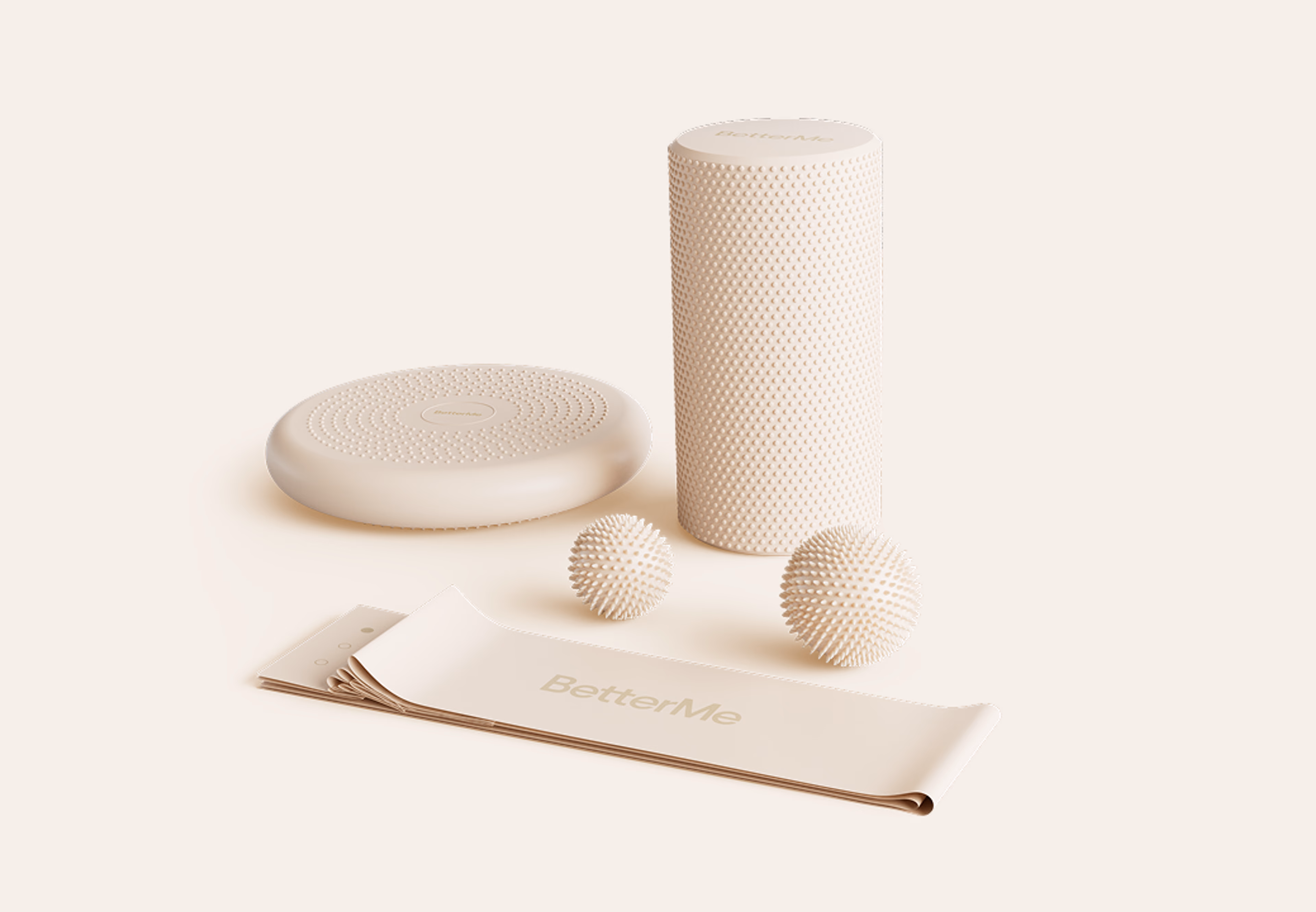 BetterMe welcome kit with a spiky massage roller, two massage balls, a balance cushion and a branded resistance band